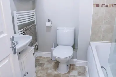 a bathroom with a toilet and a sink and a tub at Stylish 2 Bedroom Property in Bury Saint Edmunds