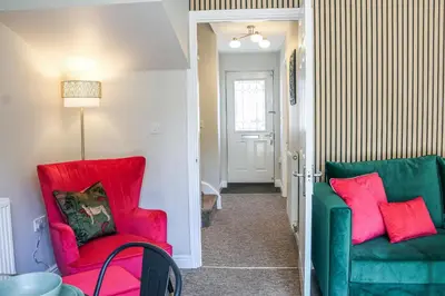 a hallway with two chairs and a table at Stylish 2 Bedroom Property in Bury Saint Edmunds