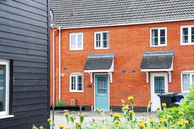 a red brick house with a blue door at Stylish 2 Bedroom Property in Bury Saint Edmunds