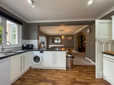 a kitchen with a washer and dryer at Seafront Beach House in Southend-on-Sea