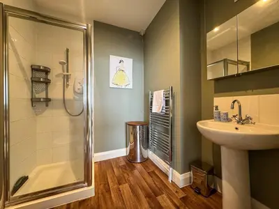 a bathroom with a shower and a sink at Seafront Beach House in Southend-on-Sea