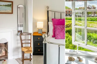 a room with a bed and a window at Stunning estuary views - Riverside Cottage in Snape