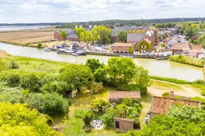 an aerial view of a small town next to a river at Stunning estuary views - Riverside Cottage in Snape