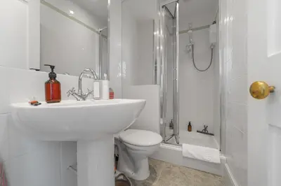 a white bathroom with a sink and a toilet at 28 Church Ponds, Castle Hedingham in Castle Hedingham
