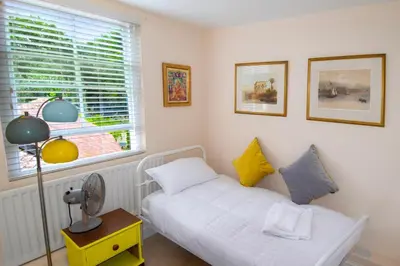 a small room with a bed and a window at 28 Church Ponds, Castle Hedingham in Castle Hedingham