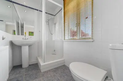 a white bathroom with a toilet and a sink at 28 Church Ponds, Castle Hedingham in Castle Hedingham