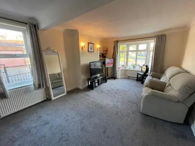 a living room with a couch and a television at Ouse River Quay Hill Lodge in Littleport