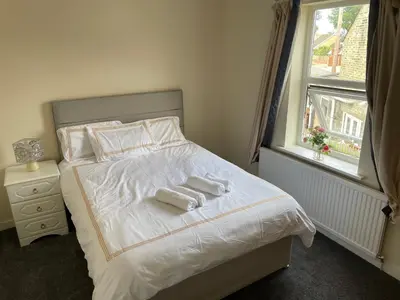 a bedroom with a bed with two towels on it at Ouse River Quay Hill Lodge in Littleport