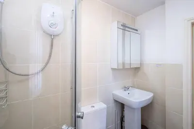 a bathroom with a shower and a sink at Pebbles, King St - Aldeburgh Coastal Cottages in Aldeburgh