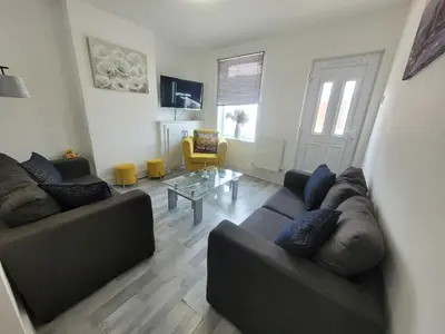 a living room with two couches and a table at Pet Friendly 2-Bed Home Near Marina & Town - Free Parking in Ipswich