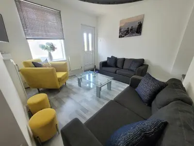 a living room with a couch and a table at Pet Friendly 2-Bed Home Near Marina & Town - Free Parking in Ipswich