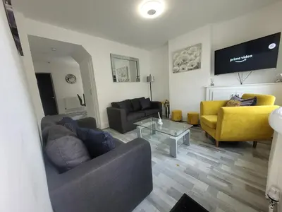 a living room with two couches and a table at Pet Friendly 2-Bed Home Near Marina & Town - Free Parking in Ipswich