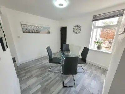 a dining room with a glass table and chairs at Pet Friendly 2-Bed Home Near Marina & Town - Free Parking in Ipswich