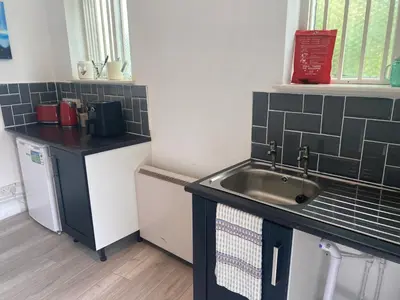 a small kitchen with a sink and a counter at The Meadows in Bishops Stortford
