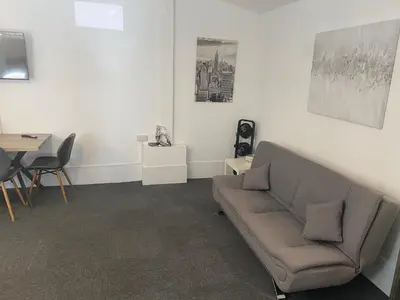 a living room with a couch and a table at The Meadows in Bishops Stortford