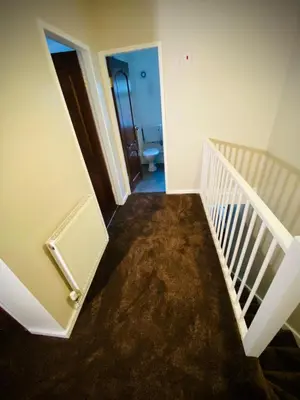 a hallway with a stairway leading to a bathroom at Modern-PetFriendly-privateGarden-Family-20MinToLDN in Stevenage