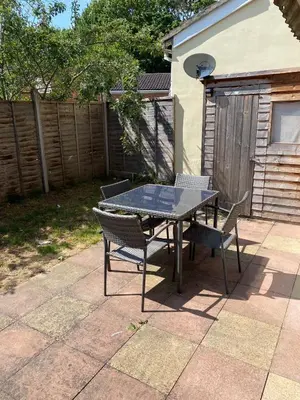 a table and chairs sitting on a patio at Modern-PetFriendly-privateGarden-Family-20MinToLDN in Stevenage