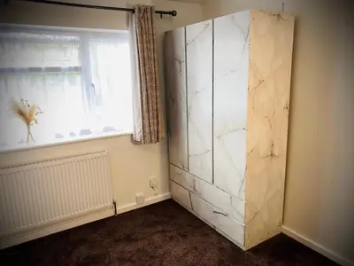 a bathroom with a white marble cabinet in front of a window at Modern-PetFriendly-privateGarden-Family-20MinToLDN in Stevenage