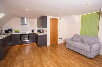 a living room with a couch and a kitchen at Newly Renovated Sanctuary for 4 in Tacket Street, Ipswich in Ipswich