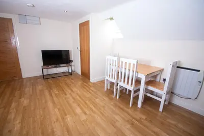 a dining room with a table and chairs and a television at Newly Renovated Sanctuary for 4 in Tacket Street, Ipswich in Ipswich