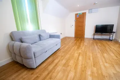 a living room with a couch and a flat screen tv at Newly Renovated Sanctuary for 4 in Tacket Street, Ipswich in Ipswich