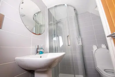 a bathroom with a sink and a shower with a mirror at Newly Renovated Sanctuary for 4 in Tacket Street, Ipswich in Ipswich