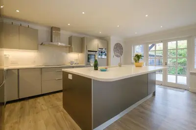 a kitchen with a large island in the middle at 8 Sanctuary, Very close to Thorpeness Meare and the beach - Aldeburgh Coastal Cottages in Thorpeness