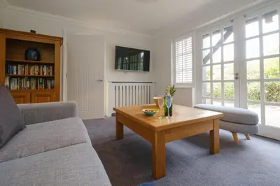 a living room with a couch and a coffee table at 8 Sanctuary, Very close to Thorpeness Meare and the beach - Aldeburgh Coastal Cottages in Thorpeness