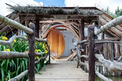 a wooden bridge leading to a house with a door at Fairytale Staycation - Near London by Damask Homes in Stapleford Tawney