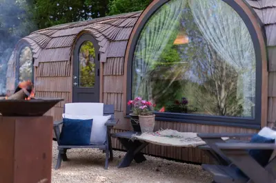 a gazebo with a table and chairs in front of it at The Lodges - Waresley Park Estate