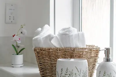 a basket of towels and a mug on a counter at Stylish 5Bedroom Getaway in Quiet Mildenhall Area in Mildenhall