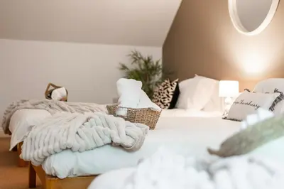 a bedroom with two beds with towels on them at Stylish 5Bedroom Getaway in Quiet Mildenhall Area in Mildenhall