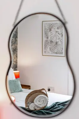 a mirror reflection of a bed in a bedroom at Stylish 5Bedroom Getaway in Quiet Mildenhall Area in Mildenhall
