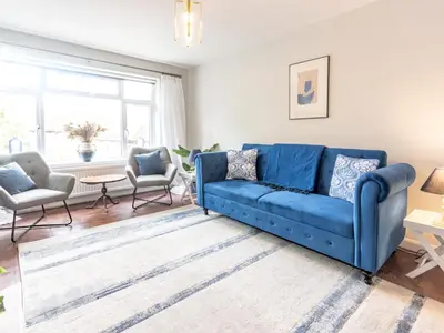a living room with a blue couch and two chairs at Stylish 2-Bedroom Flat in Great Warley – Sleeps 6 Pass the Keys in Great Warley Street
