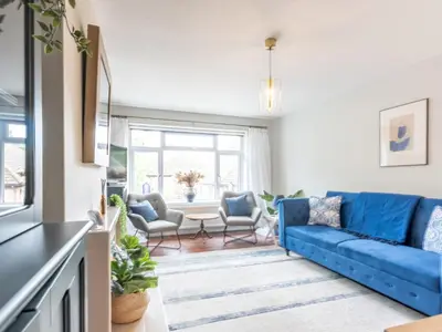 a living room with a blue couch and chairs at Stylish 2-Bedroom Flat in Great Warley – Sleeps 6 Pass the Keys in Great Warley Street