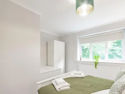 a white bedroom with a bed and a window at Stylish 2-Bedroom Flat in Great Warley – Sleeps 6 Pass the Keys in Great Warley Street