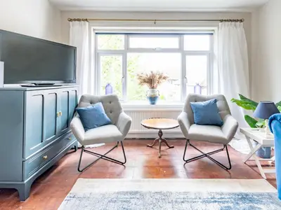 a living room with two chairs and a flat screen tv at Stylish 2-Bedroom Flat in Great Warley – Sleeps 6 Pass the Keys in Great Warley Street