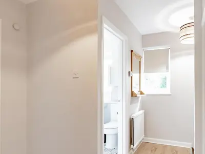 a bathroom with a toilet and a window at Stylish 2-Bedroom Flat in Great Warley – Sleeps 6 Pass the Keys in Great Warley Street
