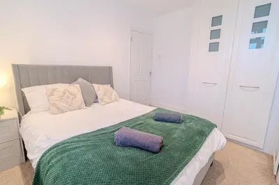 a bedroom with a bed with two pillows on it at Stylish Southend Stay in Southend-on-Sea