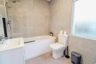 a bathroom with a tub and a toilet and a sink at Stylish Southend Stay in Southend-on-Sea