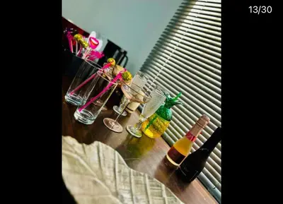 a group of bottles and glasses sitting on a table at Hertford Home detached garden parking pet allowed in Hertford