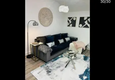 a living room with a couch and a table at Hertford Home detached garden parking pet allowed in Hertford