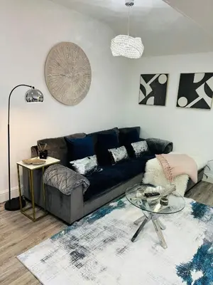 a living room with a couch and a glass table at Hertford Home detached garden parking pet allowed in Hertford