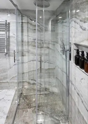 a shower with a glass door in a bathroom at The Courtyard Lodge in Hitchin