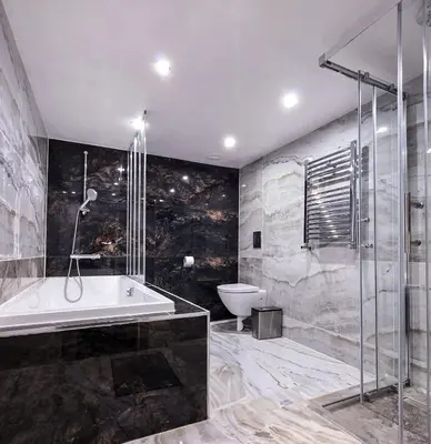 a bathroom with a bath tub and a toilet at The Courtyard Lodge in Hitchin