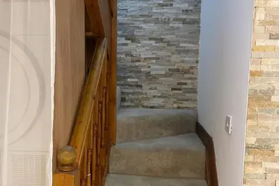 a staircase in a house with a brick wall at 4-Bed Barnwell Retreat- Sleeps10 Garden & Parking in Stevenage