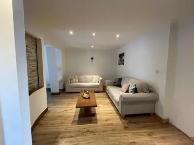 a living room with a couch and a table at 4-Bed Barnwell Retreat- Sleeps10 Garden & Parking in Stevenage