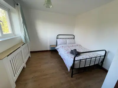 a small bedroom with a bed and a window at 4-Bed Barnwell Retreat- Sleeps10 Garden & Parking in Stevenage