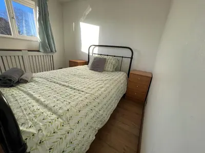 a bedroom with a bed and a window at 4-Bed Barnwell Retreat- Sleeps10 Garden & Parking in Stevenage