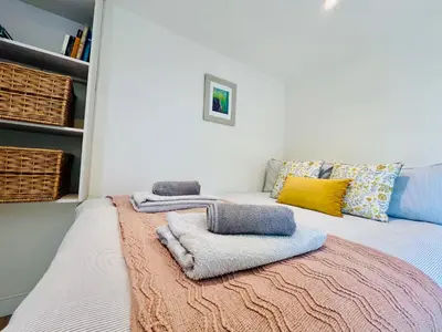 a bedroom with a bed with towels on it at Romantic Cabin Retreat on 50-Acre Suffolk Farm in Burgh